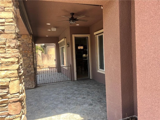 8209 Chapelle Ct, Las Vegas, NV 89131 - view of exterior entry featuring ceiling fan, stucco siding, and stone siding
