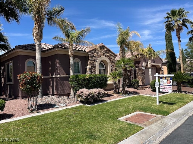 8209 Chapelle Ct, Las Vegas, NV 89131 - mediterranean / spanish house with stucco siding, a front lawn, and a tiled roof