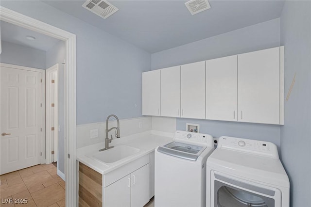 8209 Chapelle Ct, Las Vegas, NV 89131 - laundry room featuring cabinet space, washer and dryer, and light tile patterned floors