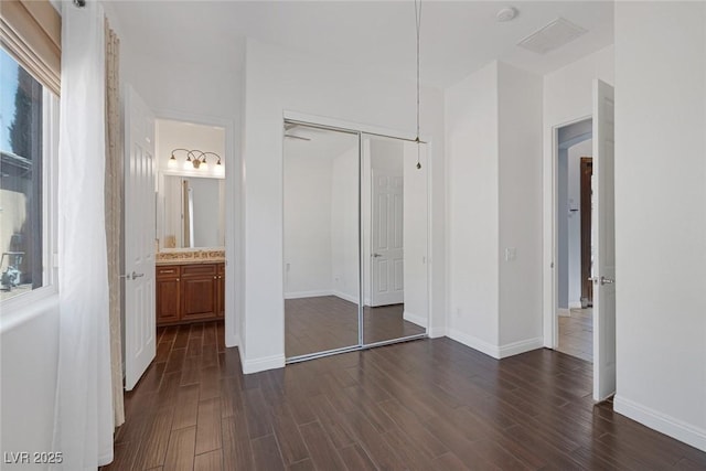 8209 Chapelle Ct, Las Vegas, NV 89131 - unfurnished bedroom with dark wood-style floors, a closet, baseboards, and ensuite bath