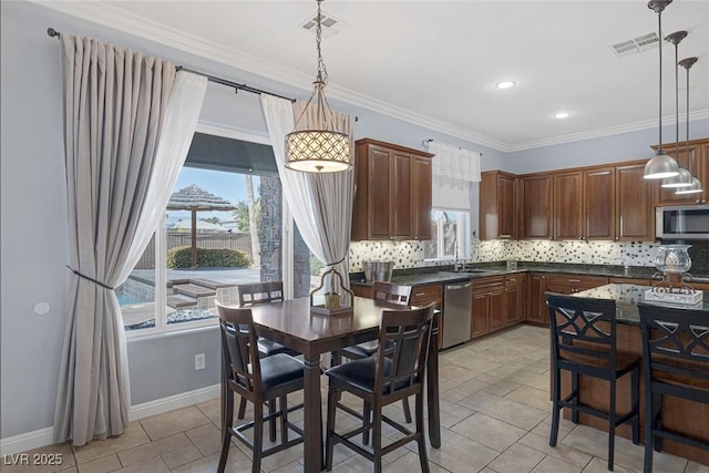8209 Chapelle Ct, Las Vegas, NV 89131 - kitchen with appliances with stainless steel finishes, dark countertops, tasteful backsplash, light tile patterned flooring, and crown molding