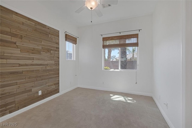 8209 Chapelle Ct, Las Vegas, NV 89131 - spare room featuring wooden walls, carpet flooring, a ceiling fan, and baseboards