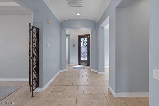 8209 Chapelle Ct, Las Vegas, NV 89131 - entrance foyer featuring arched walkways, crown molding, baseboards, light tile patterned flooring, and recessed lighting