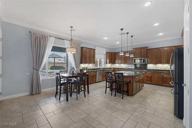 8209 Chapelle Ct, Las Vegas, NV 89131 - kitchen with stainless steel appliances, decorative backsplash, plenty of natural light, crown molding, and recessed lighting