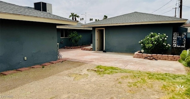 1801 Griffith Ave, Las Vegas, NV 89104 - rear view of house featuring a patio area, roof with shingles, and stucco siding