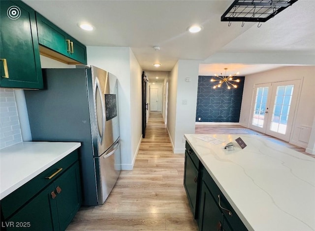 1801 Griffith Ave, Las Vegas, NV 89104 - kitchen featuring green cabinets, freestanding refrigerator, light wood-style flooring, recessed lighting, and a chandelier