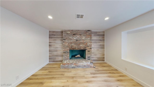 1801 Griffith Ave, Las Vegas, NV 89104 - unfurnished living room with recessed lighting, a brick fireplace, and wood finished floors