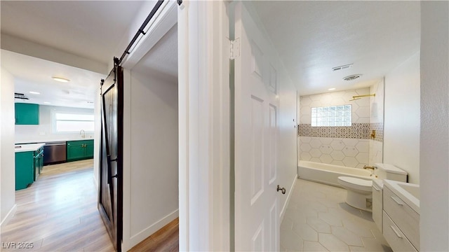 1801 Griffith Ave, Las Vegas, NV 89104 - bathroom featuring vanity, plenty of natural light, bathtub / shower combination, and wood finished floors
