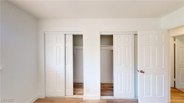 1801 Griffith Ave, Las Vegas, NV 89104 - unfurnished bedroom featuring multiple closets and light wood-style flooring