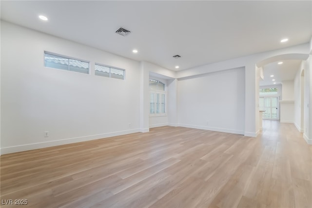 3057 Sunrise Heights Dr, Henderson, NV 89052 - empty room featuring baseboards, light wood-type flooring, arched walkways, and recessed lighting