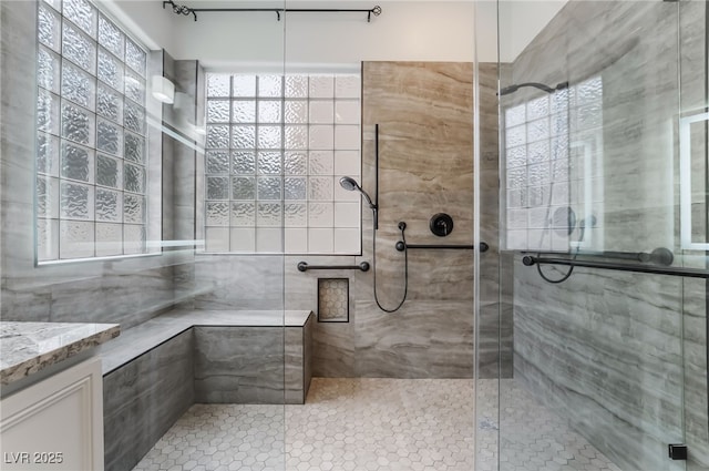 3057 Sunrise Heights Dr, Henderson, NV 89052 - full bath featuring a tile shower, a healthy amount of sunlight, vanity, and tile patterned flooring