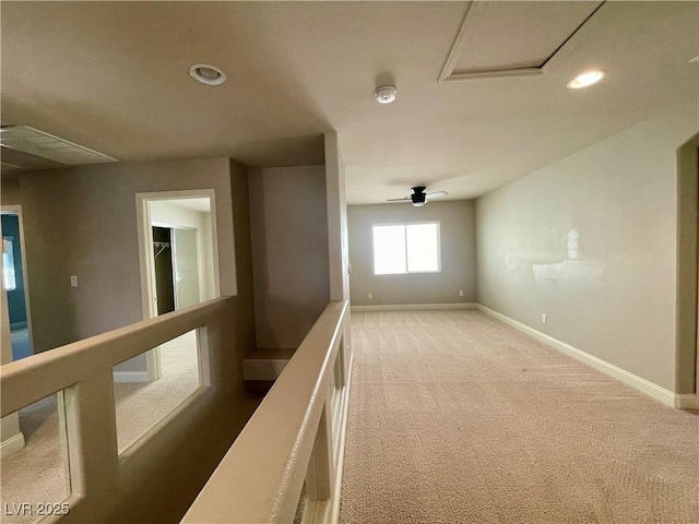 corridor featuring an upstairs landing, baseboards, carpet, and recessed lighting