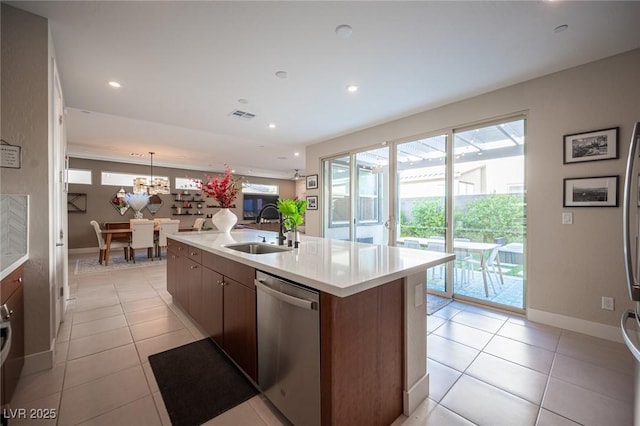 kitchen with light tile patterned floors, light countertops, visible vents, stainless steel dishwasher, and a sink
