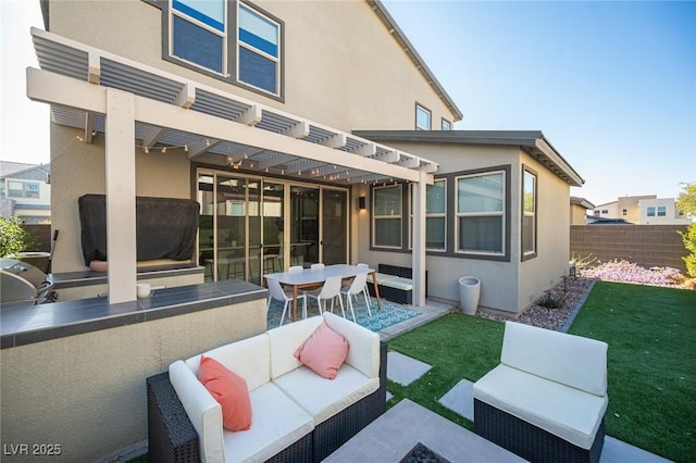 view of patio / terrace with an outdoor living space, a pergola, a grill, fence, and exterior kitchen