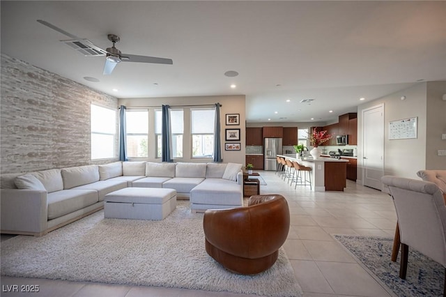 living room with recessed lighting, visible vents, light tile patterned flooring, and ceiling fan