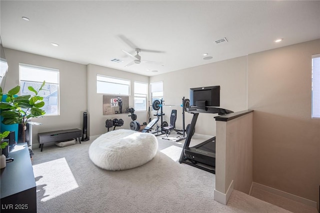workout room featuring carpet, visible vents, baseboards, and ceiling fan