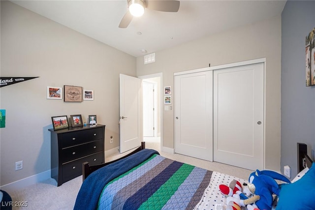 bedroom with a closet, baseboards, and ceiling fan