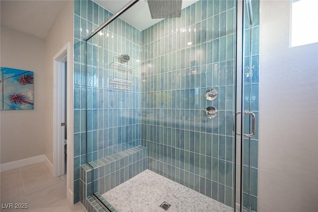 bathroom featuring a shower stall, tile patterned floors, and baseboards