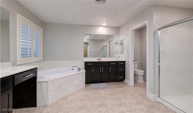full bath with a bath, toilet, vanity, tile patterned floors, and a stall shower