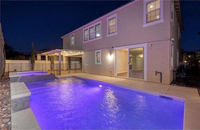 pool at night with a pergola, fence, a patio, an in ground hot tub, and a fenced in pool