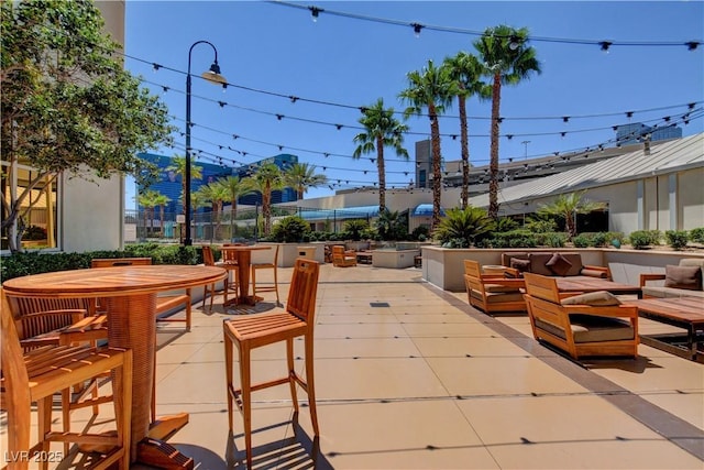 view of patio / terrace with outdoor dining space and an outdoor hangout area