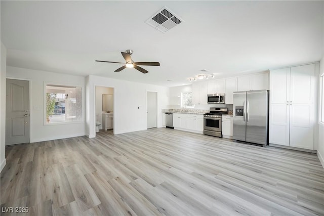 kitchen with stainless steel appliances, light wood-style flooring, visible vents, and a healthy amount of sunlight
