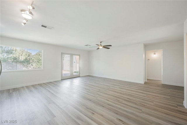 unfurnished living room featuring french doors, visible vents, baseboards, ceiling fan, and light wood-style floors