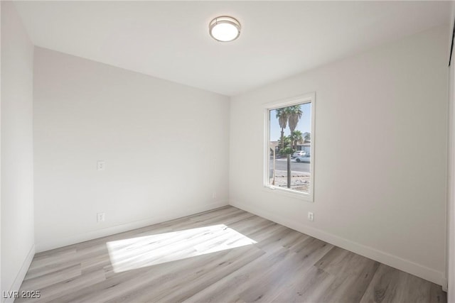 empty room with wood finished floors and baseboards