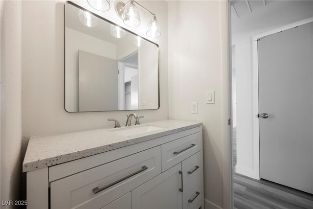 bathroom with wood finished floors and vanity