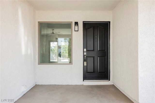 view of exterior entry with stucco siding
