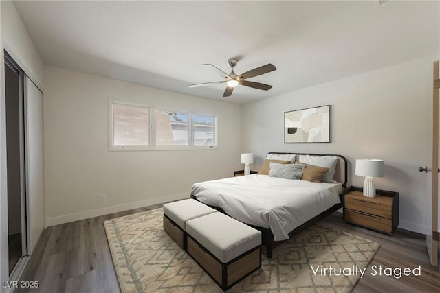 bedroom with ceiling fan, baseboards, a closet, and wood finished floors