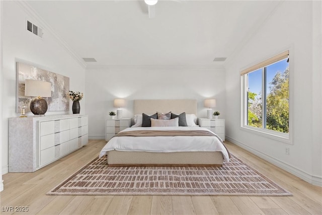 bedroom with wood finished floors, visible vents, baseboards, lofted ceiling, and ornamental molding