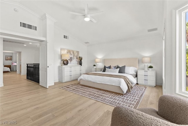 bedroom with ornamental molding, visible vents, and light wood-style floors