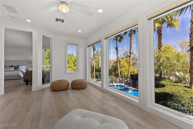 sunroom with hardwood / wood-style flooring, visible vents, and recessed lighting