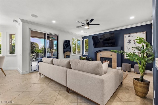 living room with ceiling fan, light tile patterned flooring, and ornamental molding