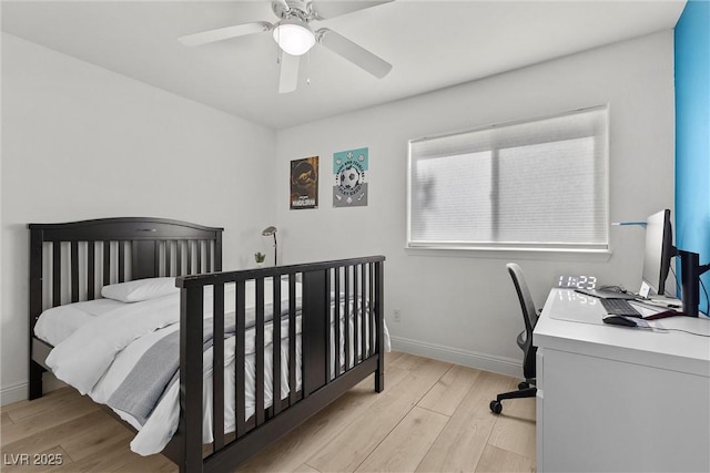 bedroom with light wood finished floors, baseboards, and ceiling fan