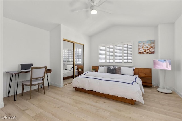 bedroom featuring baseboards, wood finished floors, lofted ceiling, and ceiling fan