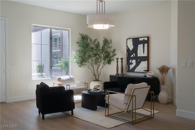 sitting room with wood finished floors and baseboards