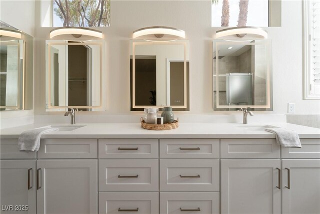 full bath featuring double vanity and a shower with door