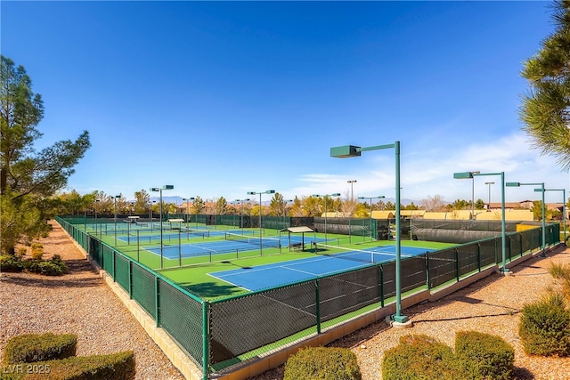 view of tennis court featuring fence