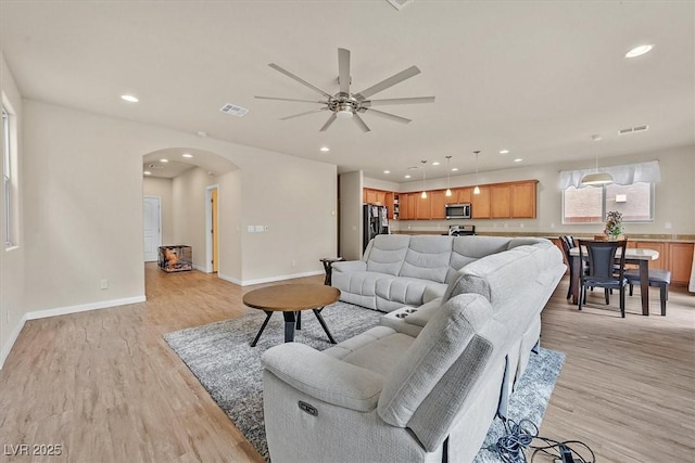 8919 Don Valley Ave, Las Vegas, NV 89148 - living room with visible vents, a ceiling fan, recessed lighting, arched walkways, and light wood-style flooring