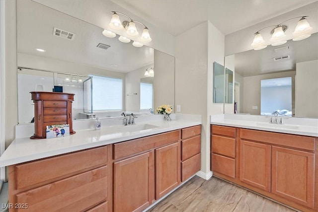 8919 Don Valley Ave, Las Vegas, NV 89148 - bathroom featuring visible vents, a sink, and wood finished floors