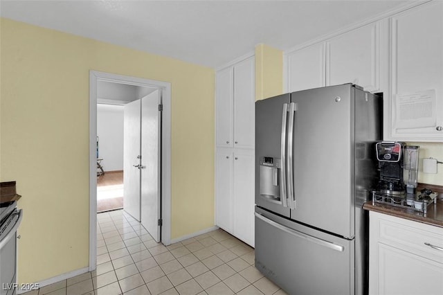 1800 Red Rock Dr, Pahrump, NV 89048 - kitchen featuring light tile patterned flooring, dark countertops, white cabinetry, and stainless steel refrigerator with ice dispenser