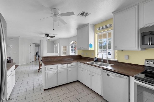 1800 Red Rock Dr, Pahrump, NV 89048 - kitchen featuring ceiling fan, visible vents, appliances with stainless steel finishes, a sink, and dark countertops