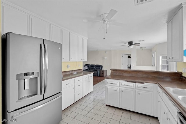 1800 Red Rock Dr, Pahrump, NV 89048 - kitchen with stainless steel appliances, dark countertops, a peninsula, and ceiling fan