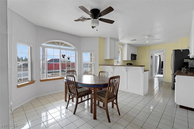 1800 Red Rock Dr, Pahrump, NV 89048 - dining room featuring ceiling fan, light tile patterned flooring, and baseboards