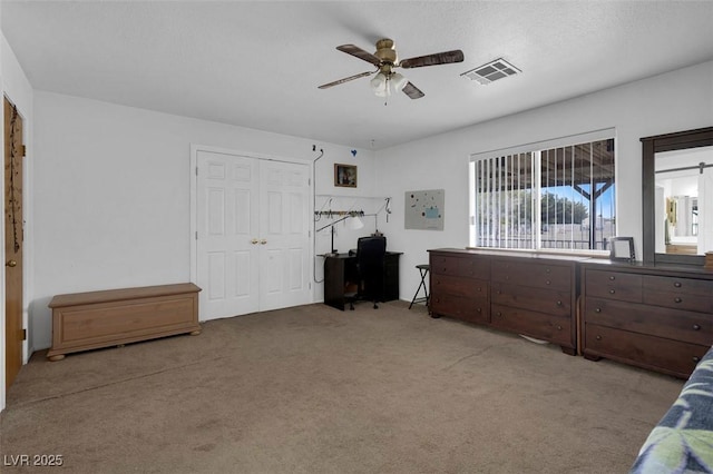 1800 Red Rock Dr, Pahrump, NV 89048 - bedroom with light carpet, visible vents, a closet, and ceiling fan