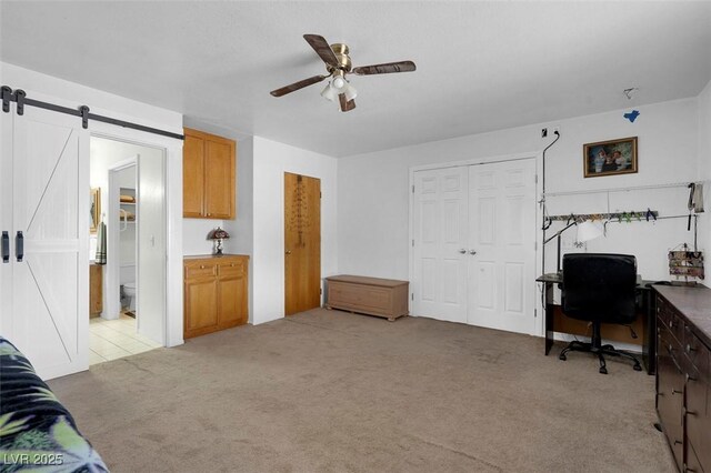 1800 Red Rock Dr, Pahrump, NV 89048 - office area featuring ceiling fan, light colored carpet, and a barn door