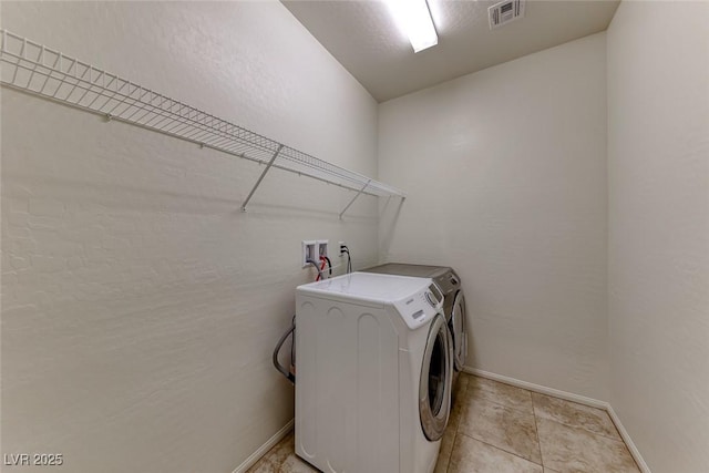 washroom featuring separate washer and dryer and baseboards