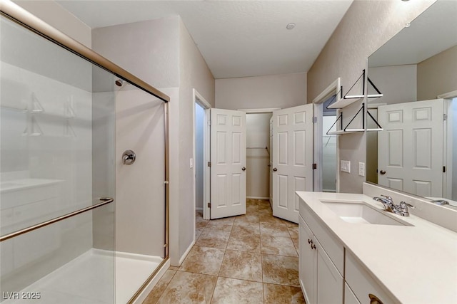 full bathroom with a shower stall and vanity
